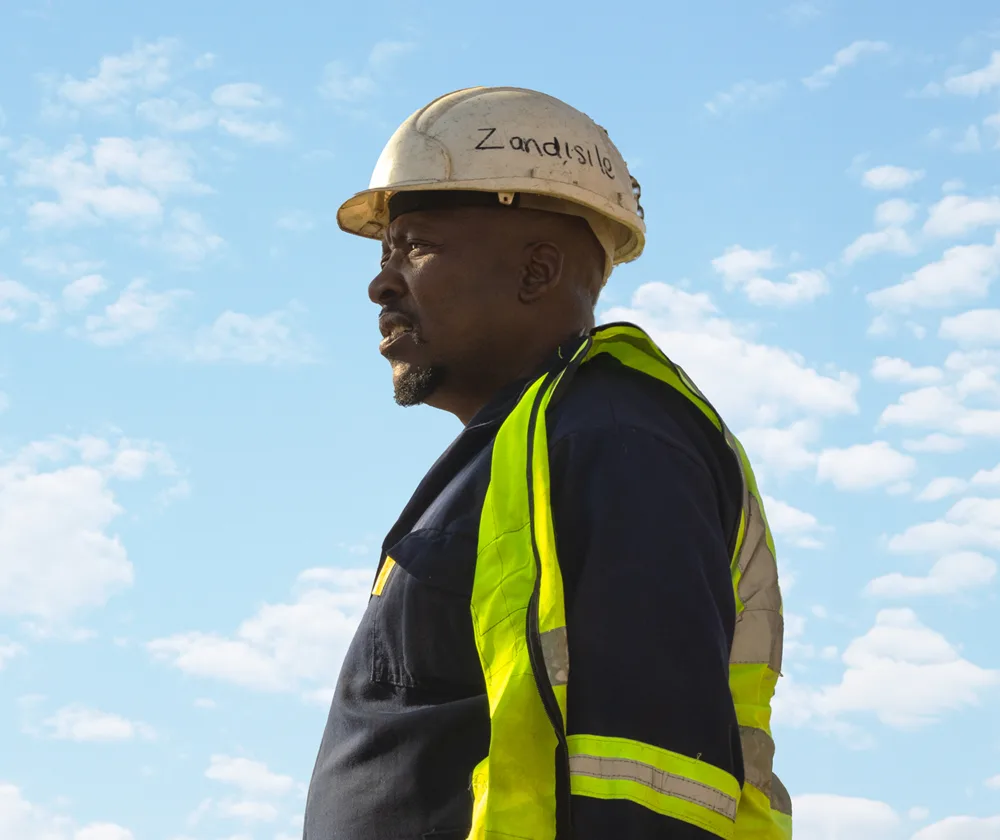 Construction worker on site wearing a high-visibility vest.