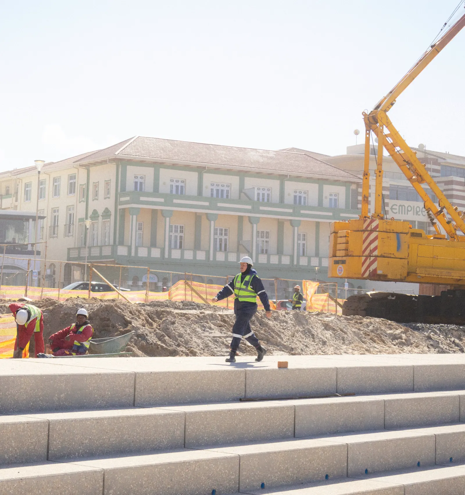 South African construction workers on an active site, showing the kind of field teams that use WorkWeek for attendance, payroll calculations, and site operations.